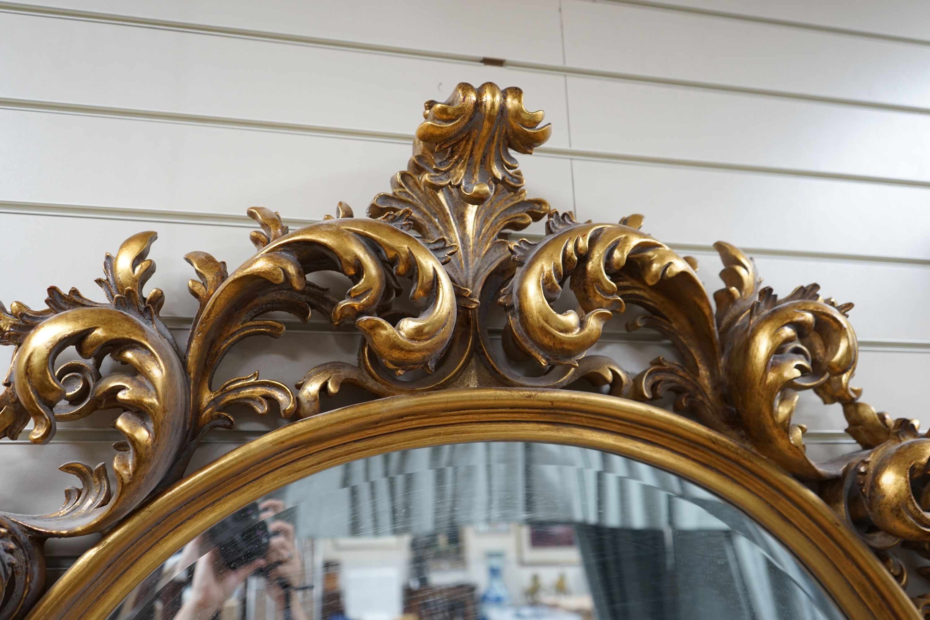 A large moulded gilt frame oval mirror, width 112cm height 110cm